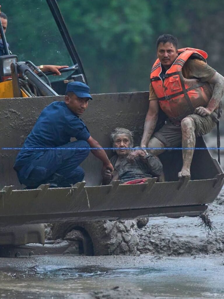 Nepal flood rescue: excavator carrying survivor to safety in Rasuwa